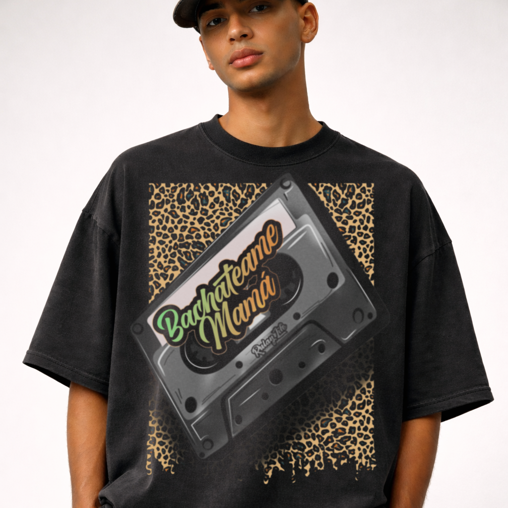 Person wearing a black t-shirt with a cassette tape graphic and 'Bachateame Mama' text. Dominican Shirt, black, Dominican pattern— Heavy Oversized Shirt, Rulay Life design Premium fabric, limited drops. Shop Rulay Life. Dominican own brand.