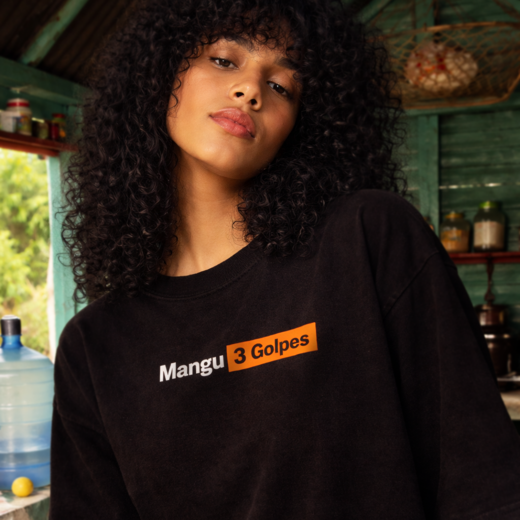 Person wearing a black t-shirt with text in an inside traditional old school Dominican house from el campo