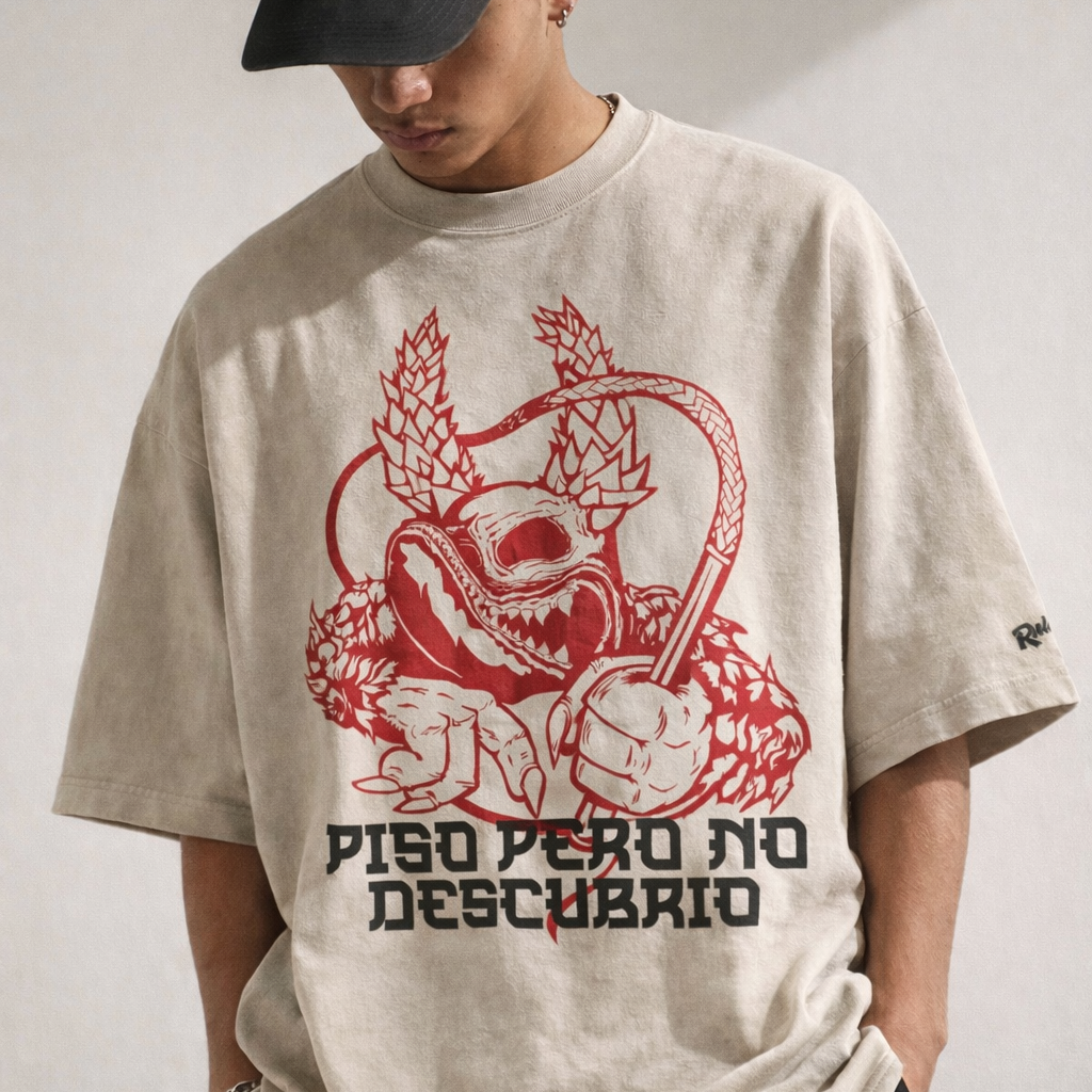 Dominican brand  Person wearing a beige t-shirt with a red graphic design and text on a plain background.Premium fabric, limited drops. Shop Rulay Life.