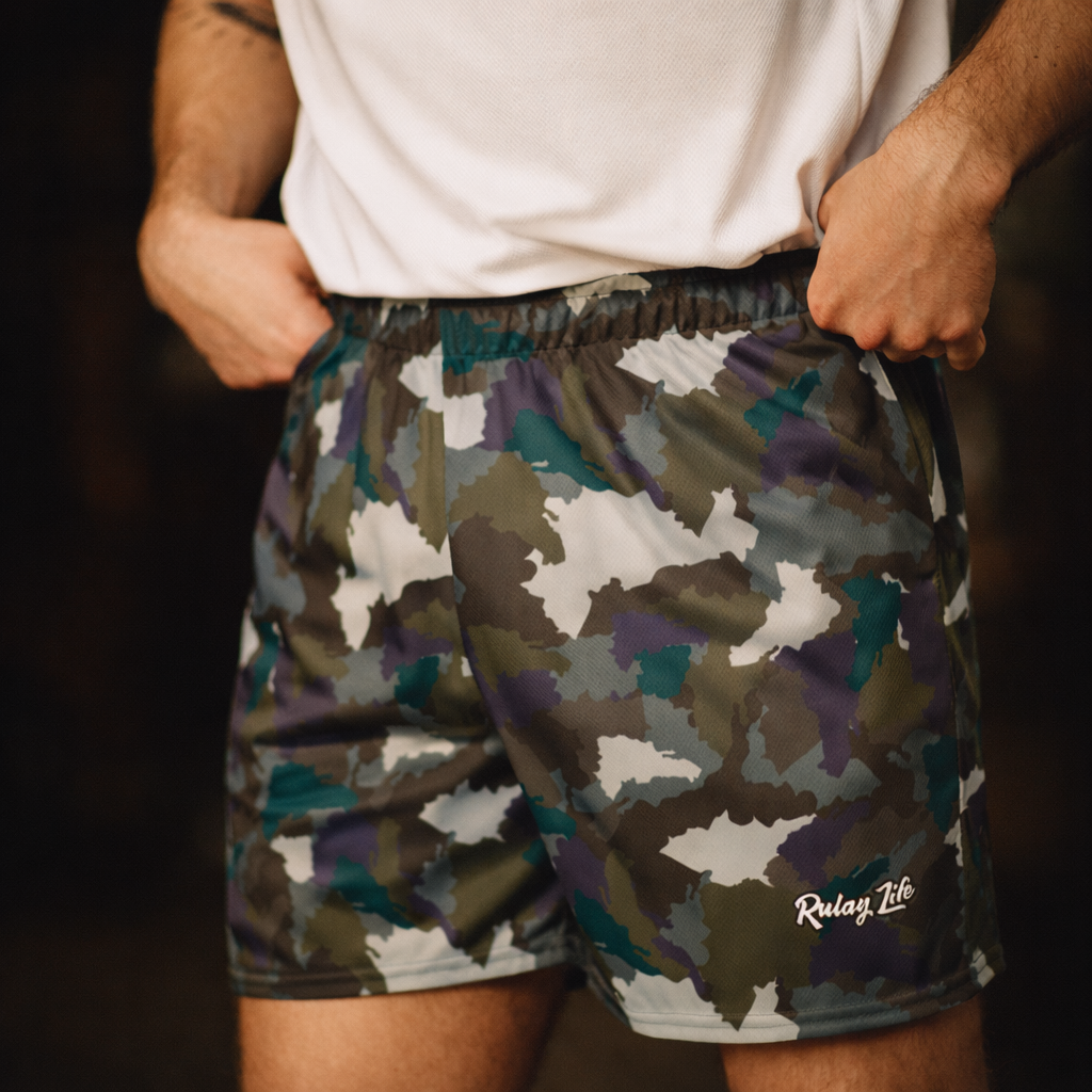 Camouflage shorts with a brand logo on a dark background. Midnight Desert Dominican shorts